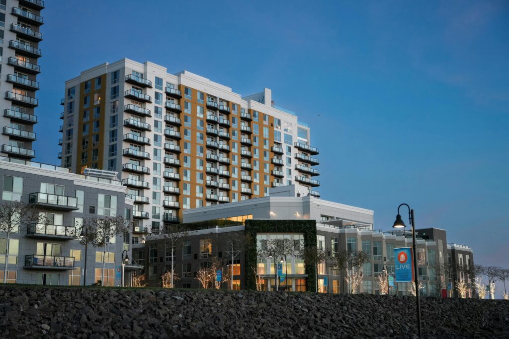 Contemporary apartment complex under a clear twilight sky, showcasing urban architecture.