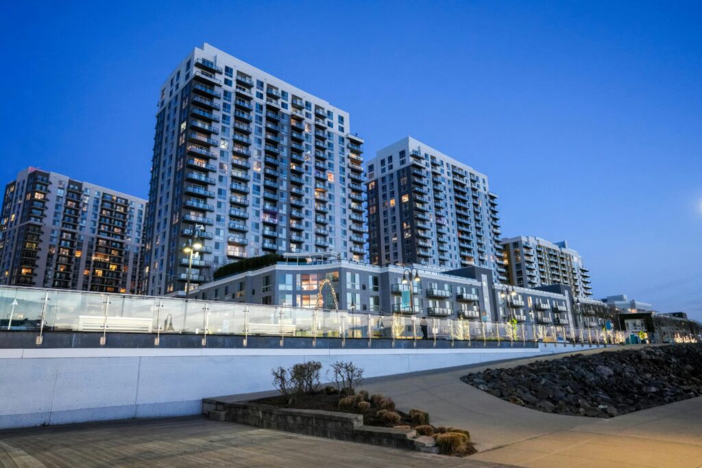 High-rise apartment buildings against a twilight sky, featuring modern architecture.